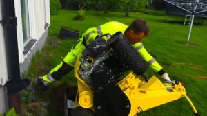 Man Pushing the L2 Line Layer machine